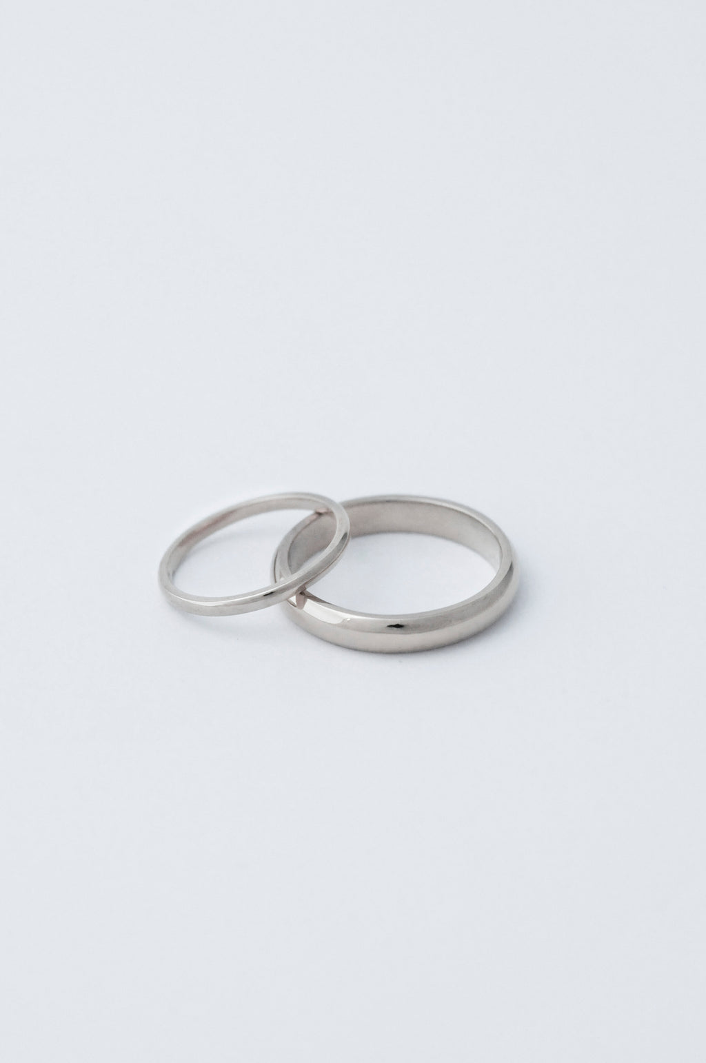 D shaped classic wedding band in platinum. 2mm ring stacked on the side of a 5mm ring