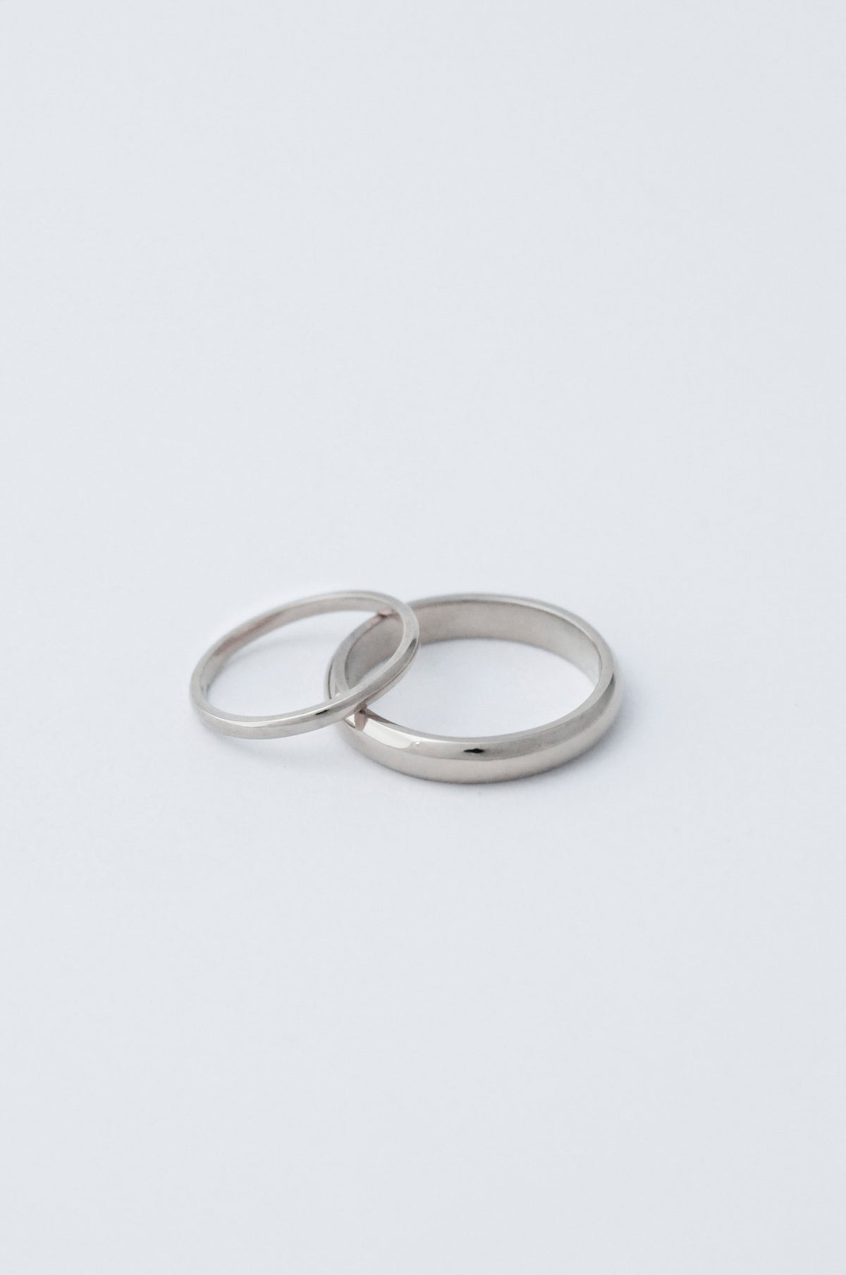 D shaped classic wedding band in platinum. 2mm ring stacked on the side of a 5mm ring